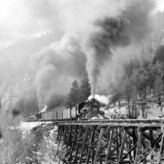 Three-quarter view of left side of engine, from front end; on trestle, with helper engine 452; smoke; snow. Photographed: Wade, Colorado,  November 19, 1951.