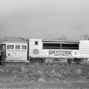 Left side view of motor car, close view; Galloping Goose, with C.A. Rhodes in doorway. Photographed: Peak, Colorado, May 23, 1951.