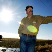 (YUMA., Colo., Dec. 12, 2005) Kenny Rogers leans against his truck, near a piece of property where the family rents out farm land. The Rogers family in Yuma, Colorado has maintained the Wagon Wheel Ranch since 1950. They have participated in the Nation...