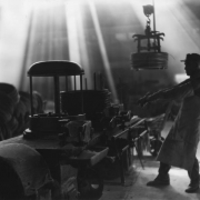 Interior view of Colorado Fuel and Iron Company (Corporation), Pueblo, Colorado, a steel and iron manufacturing plant; shows male employee  operating a machine which produces steel wire from steel rods.