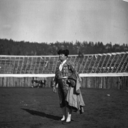 View of bullfighters in small stadium in Gillett, Colorado, includes a matador in Mexican attire, a wooden arena, bulls and wooden bleachers in the background. The matador's costume includes hat, vest, sash, epaulets, "pink" stockings, slippers, and an embroidered ornamental jacket and pants. The matador, possibly Senor Jose Marrero, holds a cape. He is one of three Mexican matadors hired by "La Fiesta Bullfights" promoter Joe Wolfe, August 24-26, 1895.
