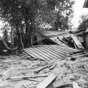 Mud and debris with damaged wood frame structures brought down by  the Cornet Creek flood on July 27, 1914, Telluride, Colorado.