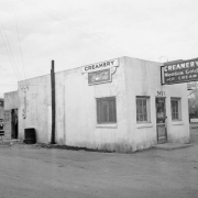View of a business in Denver, Colorado; signs read "Creamery Meadow Gold Ice Cream," "Rainbo Bread," "Coca Cola," and "3457."
