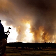 Eugene Brumley tries to get in a round of golf as the Hayman Fire rages.