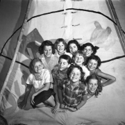 Camp Fire Girls smile and pose in a tipi in Denver, Colorado.