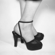 View of a woman model's feet in a pair of  high heeled, open toed sandals with cork soles, advertising copy for Neusteters department stores in Colorado.