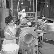 Interior view at the Leadville Hospital in Leadville (Lake County), Colorado; women work in the laundry. Shows a washing machine, a mangle and a steam press.