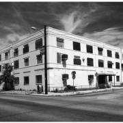 View of a three story brick commercial building at 28th (Twenty eighth) Street and Welton Street in the Five Points (or Curtis Park) Neighborhood of Denver, Colorado; features include string courses and an entry canopy.