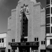 View of the Art Deco style Mayan Theater (Montana S. Fallis, architect, 1930) at 110 Broadway Street in the Speer Neighborhood of Denver, Colorado. The four story building is stone clad with Pre-Columbian motifs and a bas relief of a ritual officiate in multi-color terra cotta ornament by Julius P. Ambrusch of the Denver Terra Cotta Company. The marquee reads: "Oscar Winners, Room With A View, Color of Money, Hannah and Her Sisters, Radio Days, My Sweet Little Village."