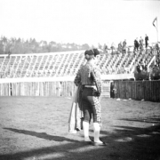 A matador, possibly Jose Marrero, looks into the stands during the bullfight on August 24 or 25, 1895, in the wood bullring built at the race track in Gillett, Colorado, for the occasion. The grandstand is almost empty, with people standing in the top row. Joe Wolfe was the organizer of the event which caused a scandal because of its cruelty to animals.