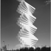 View of the Denver Art Museum's Herbert Bayer sculpture, "The Articulated Wall," at the Design Center at 595 South Broadway Street in the Baker Neighborhood of Denver, Colorado. The 85 foot sculpture has an enormous steel mast inside that is used as an armature on which stacked horizontal concrete bars have been anchored. The bars are offset so that they weave in and out and are held in place by the top member, using just the force of gravity.