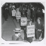 Suffragettes march in New York City with sandwich board signs that read: "Votes For Women", Women Vote In These States", "Come And Learn The Truth About Women Who Vote", and "Saturday Sep. 16th At Cooper Union At 8 PM."