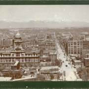 A panoramic view of Denver, Colorado; shows 16th (Sixteenth) Street, the Denver City Hall, the Arapahoe County Courthouse, the Kittredge Building, and the First Congregational Church. The Front Range is in the distance.