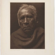 Portrait of Captain Charley, an elderly Native American (Maricopa) man. He wears a blanket and has white or gray hair.