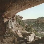 View of North American Indian (Ancestral Puebloan) dwellings in Cliff Palace at Mesa Verde National Park in Colorado. Shows masonry and mud square and round ruins under a cliff overhang on Chapin Mesa. Cliff Canyon is in the distance.