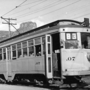 Denver City Tramway Company (Denver and Interurban Mountain Line) electric trolley car .07 at the Golden station depot of the Denver and Northwestern Railway, Jefferson County, Colorado; Castle Rock shows in background.