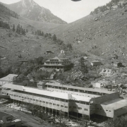 The buildings and swimming pool at the resort in Eldorado Springs, Colorado, have been reconstructed after the fire of December of 1938. Features the new pool building adjacent to South Boulder Creek, the new Eldorado Hotel, and foundations of buildings destroyed by the fire.