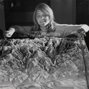 Miss Brigitte Bastian, sports secretary to the Denver Olympic Committee, surveys a scale model of Denver and surrounding mountains to be used in the city's bid for the 1976 Winter Olympic Games. Denver will make its presentation May 12 in Amsterdam.