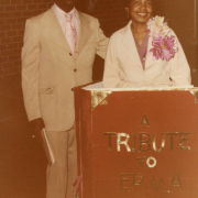 George Washington Carver Day Nursery teacher and director Erma Ford (right) stands at her retirement party with an unidentified man inside a giant book entitled "A Tribute to Erma Ford."After 34 years of service to the Carver community, Ms. Ford retired in 1980.