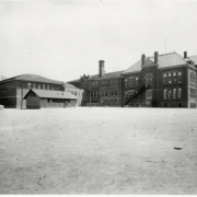 Exterior of the back of the old 24th Street School with its playground and separate buildings.  This school was  later replaced by Crofton Elementary School, in Denver, Colorado.