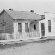 View of a clapboard business / residence in Silver Cliff, Custer County, Colorado; includes picket fence and sign: "Sing Kee Laundry," owned by Chinese immigrant Lew Sing Kee from 1885 till his death in 1927.