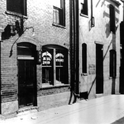 View of Ching Chung and Company Chinese store at 2019 either Wazee or Blake Street in Denver, Colorado. Chinese characters are on a nearby sign.