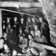 Dr. James Underhill poses with Chinese-American miners (probably) in the Colorado School of Mines' Edgar Experimental Mine near Idaho Springs (Clear Creek County), Colorado. One man holds a saw.