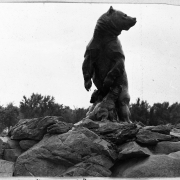 Shows the Grizzly Bear statue in City Park in Denver, Colorado. The bronze statue of a grizzly bear and two cubs was sculpted by Louis Paul Jonas in 1930 and donated by J. A. McGuire.
