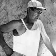 Portrait of Manuel Alvarado near Manzanola (Otero County), Colorado. He wears a tank top and baseball hat.