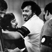 Hispanic migrant workers celebrate the end of a hunger strike to protest living conditions of workers near Fort Lupton (Weld County), Colorado. One man wears an armband that reads: "Labor Force."