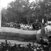 View of a Chinese dragon in a parade, part of the Festival of Mountain and Plain, in Denver, Colorado. Spectators line the street.