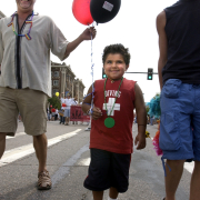 Gabriel Cunningham, 5, (middle) walks with pride and a smile with his two adopted dads, Elzie Cunningham (left) and Scott McGarrity, from Rifle, Colorado. June 27, 2004