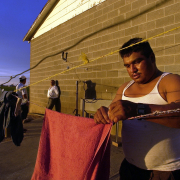 An unidentified migrant worker does his laundry after a 12-hour long day in the fields outside of Ft. Lupton June 14, 2005. Denver Archdiocese's Sister Molly Mu–oz (CQ), and the Centro Juan Diego, comes around his living quarters to offer help. Sister Mol