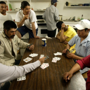 Unidentified migrant workers play "conquian" a type of rummy, after a 12-hour long day in their living quarters outside of Ft. Lupton June 14, 2005. These men are among the many to benefit from the Denver Archdiocese's Sister Molly Mu–oz (CQ), donations a