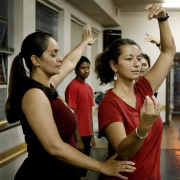 Women practice Indian dance in studio