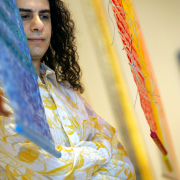 Iraqi-born artist Halim al-Karim stands among his fiber-panel "soul layers" at the Robischon Gallery.