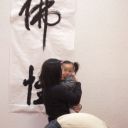 Kevin Lee, bowing, and his wife, Tze Hong, pray at the Buddhist Association of Colorado in Lakewood during a special ceremony for the Chinese New Year, which begins Wednesday. Tze Hong is holding her 2-year-old daughter, Alexis Lee.