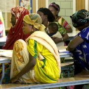 In the cafeteria of Whiteman Elementary school Somali Bantu refugee women gather wearing their traditional dress to learn English in a special class. 