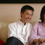 Joshua Zhong, left, and Lily Nie laugh during an interview in their Centennial home on Monday, July 17, 2006. The couple founded Chinese Children Adoption International, which has helped find homes in the United States for nearly 7,000 Chinese children.