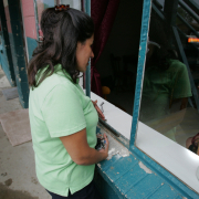 Jessica Perez, a migrant outreach coordinator for the Salud Family Health Center, speaks with a woman in her Commerce City apartment about the services offered by the center's mobile unit. Those include dental assessments, blood and other tests, and medical advice. Services are free and patients do not have to be U.S. citizens.
