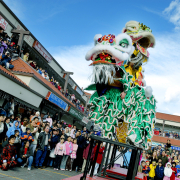 Hundreds of people watch members of Boulder's Shaolin Hung Mei Kung Fu Association perform the traditional lion dance ritual Sunday at the Far East Center on Federal Boulevard in Denver. The dance is believed to ward off evil spirits and bring luck and prosperity for the coming year.