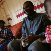 Rasulo Rasulo laughs as he sits next to his wife, Habiba Talasow, left, and niece, Hawa Musa, 2, Tuesday at Rasulo's sister and brother in law's Denver apartment. 