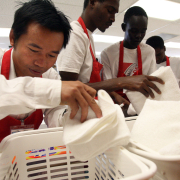 (from left) 34 year-old Thaw Dah Win from Myanmar, Cire Wane (cq) from Mauritania, and Bol Abiar (cq) from Sudan, follow directions written in English, as to how to re-stock a hotel room with sheets and towels