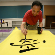 Kids at Global Leadership will begin taking chinese at fifth grade. Chinese teacher  Norman Kao (pronounced "cow") sets up his classroom Thursday Aug. 9, 2007 by writhing Chinese characters on paper to later be posted around the classroom.  AHMAD TERRY 