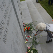 Family members and friends of the Japanese-American community place flowers at the base of the memorial stone at the Fairmount Cemetery in Denver which honors all of the Japanese-Americans who fought and died during World War II.