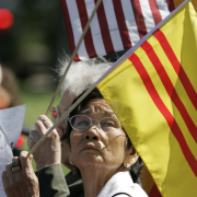 Lien Nguyen (cq) and  Ngoc Dang (cq) from left, wave an American and Free Vietnamese Flag during ceremonies at the 74th Anniversary of the Remembrance Dedicated to America's Veterans of All Wars, at Ft. Logan National Cemetery on Memorial Day
