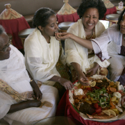 This World Plate feature profiles Tsehay Hailu (cq), the owner of Ras Kassa's, an Ethiopian restaurant in Boulder.  Tsehay's daughter Atsede Demelash (cq) (far right) pops a bite of delicious Ethiopian food into her aunt Fekerte Hailu's (cq) mouth