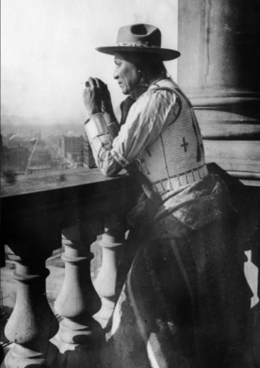 Native American man looks over Denver from Capitol 1910-1930