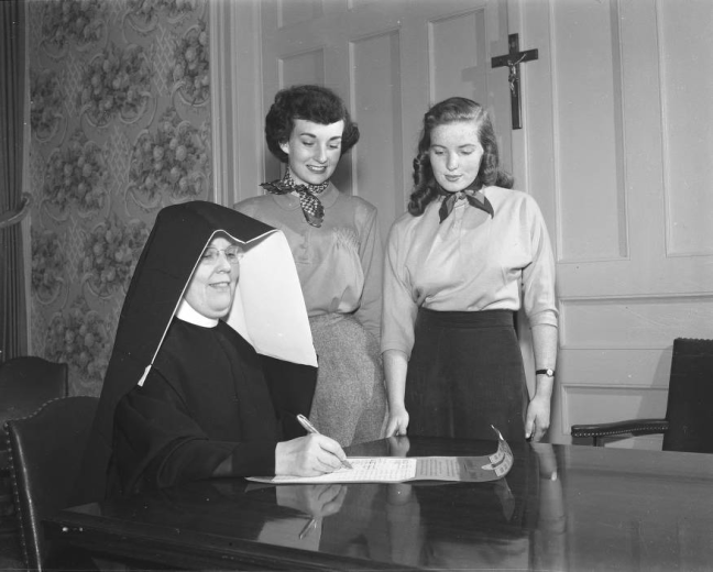 Women look on as a Sister of Loretto nun fills out a form at Loretto Heights in 1950.  (DPL Digital Collections)