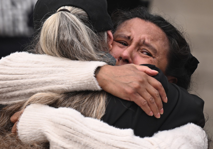 Jeanette Vizguerra, right, hugs her friend and fellow immigrant-rights activist Jenn Piper as she arrives to address supporters during a news conference outside the Alfred A. Arraj Courthouse in Denver on Tuesday. (Photo by RJ Sangosti/The Denver Post)